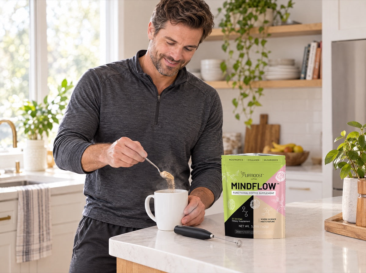 Man in workout clothes spooning Mindflow into a mug of hot water at a kitchen counter, next to a bag of Mindflow and a handheld frother